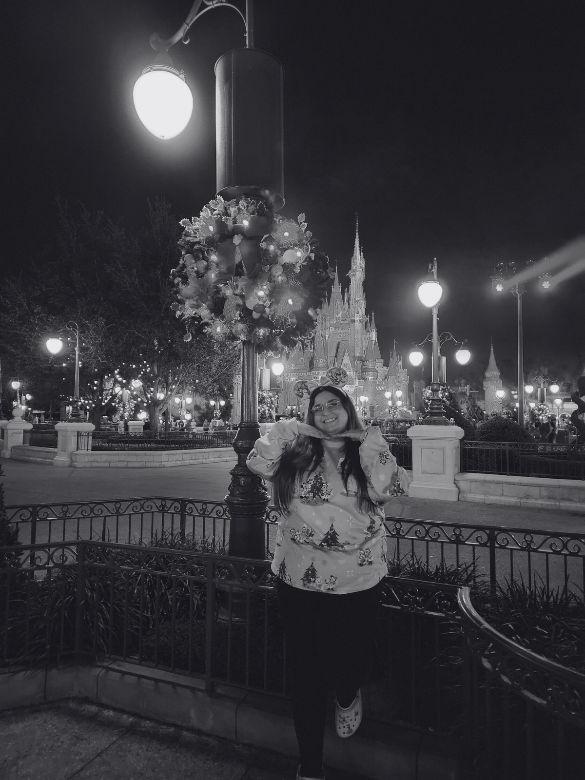 a photo of a person posing in front of the Cinderella Castle.
